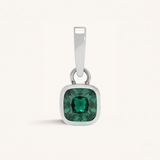 Silver pendant with a green gemstone on a white background.