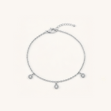 Silver bracelet with small charms on a white background