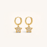 Gold star-shaped earrings with clear stones on a white background.