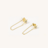 Gold chain earring with star design on a white background