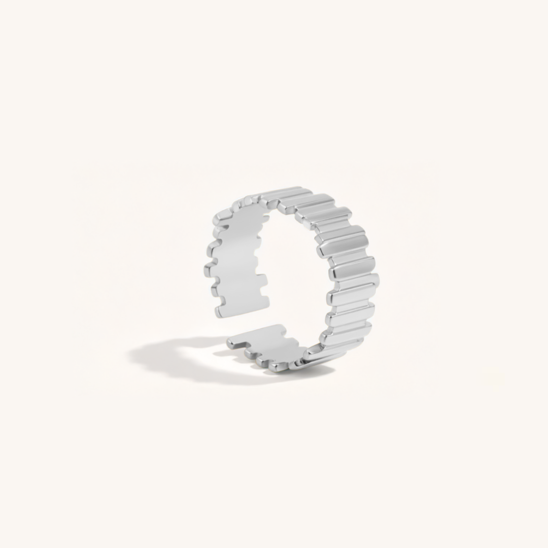 Silver ring with a unique design on a white background