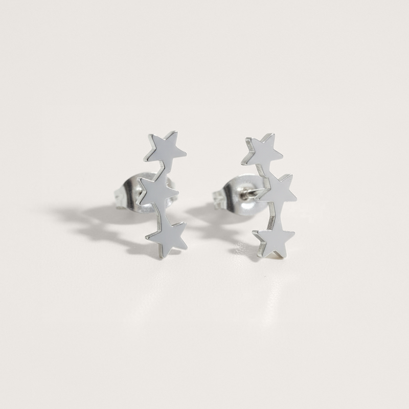 Triple star ear climber earrings in silver on white background